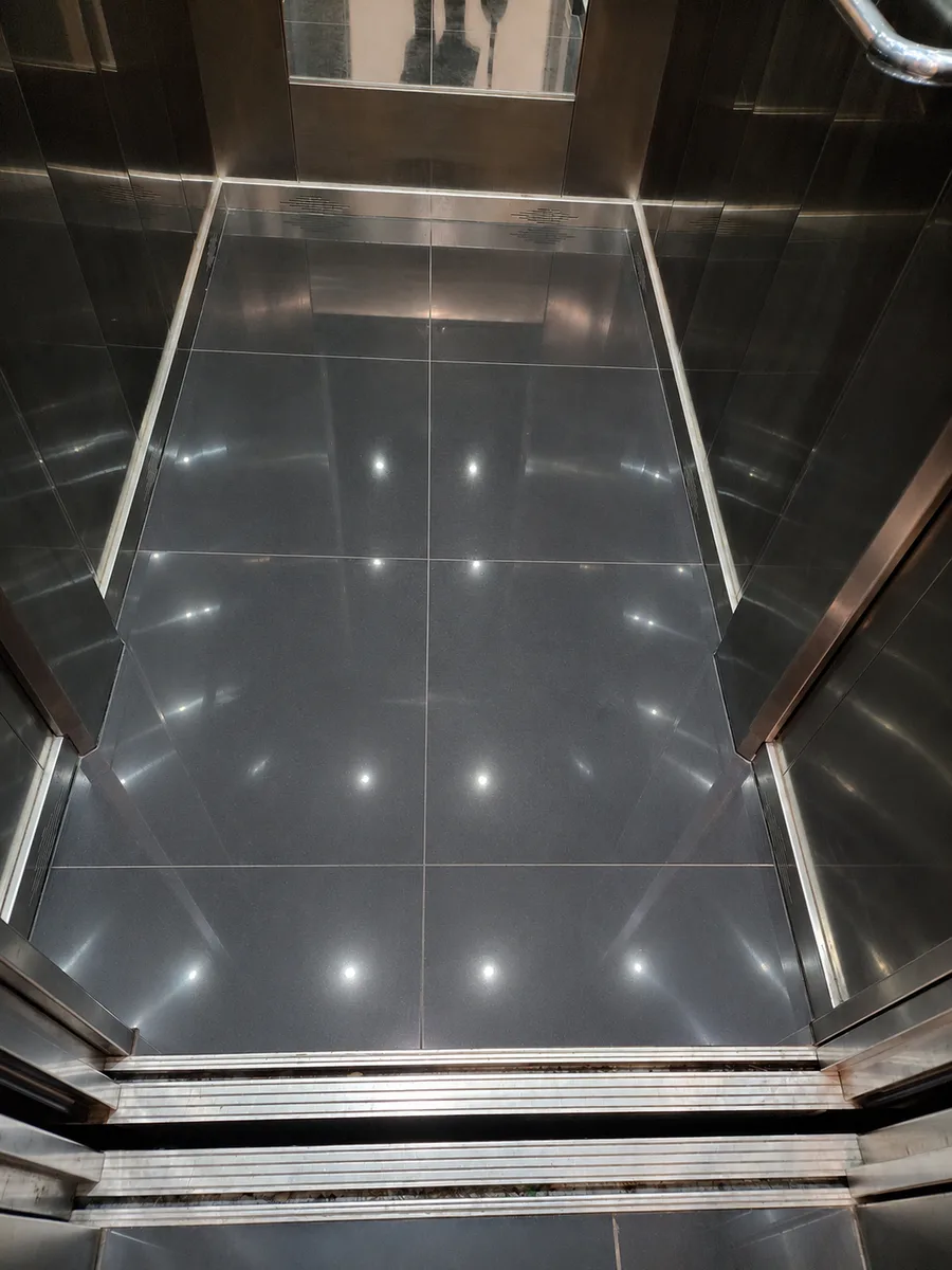 The same lift floor after the clean, polished and streak-free